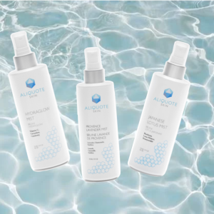 Three Aliquote Skin facial mists—Hydraglow, Provence Lavender, and Japanese Lotus—on a blue water background.